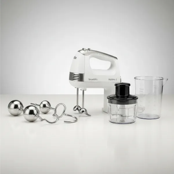 A Braun MultiMix 5 hand mixer displayed with its various attachments, including MultiWhisks and dough hooks.